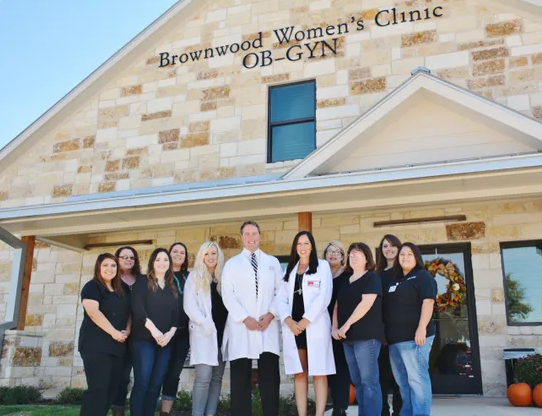 The Brownwood Women's Clinic OB-GYN team standing in front of the clinic building in Brownwood, TX